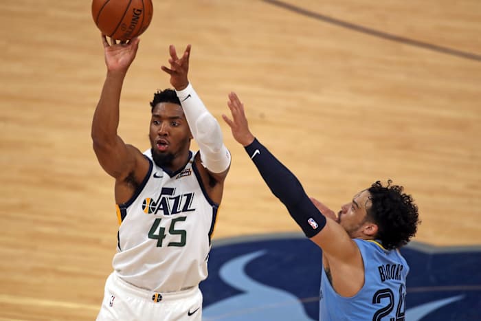 Donovan Mitchell (45) shoots a three pointer over Dillon Brooks (24)